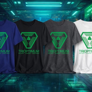 May include: Four short-sleeved t-shirts in navy blue, black, charcoal gray, and white. Each shirt features a green geometric logo and the text "TRIOPTIMUM MILITARY - SCIENCE - CONSUMER". The shirts are displayed on a reflective surface.