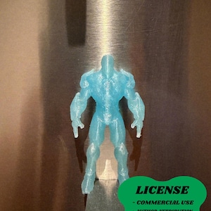 May include: A translucent blue figurine of a muscular figure. The figure is standing upright with arms at its sides. A green graphic with the word "LICENSE" and other text is in the lower right corner. The artist's name, "@tritelta", is in the lower left corner.