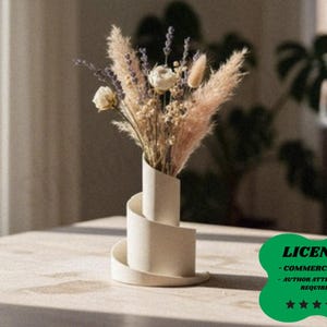 May include: A cream-colored, spiral-shaped ceramic vase holding a bouquet of dried flowers. The arrangement includes beige pampas grass, lavender, and white roses. The vase sits on a light-colored wooden table, creating a neutral, minimalist aesthetic.