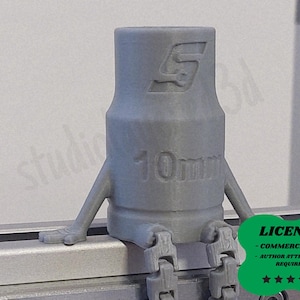 May include: A gray 3D-printed socket wrench with arms and legs, sitting on a metal surface. The wrench is marked with "10mm" and a logo. A green badge with the word "LICENSE" and star ratings is in the lower right corner.