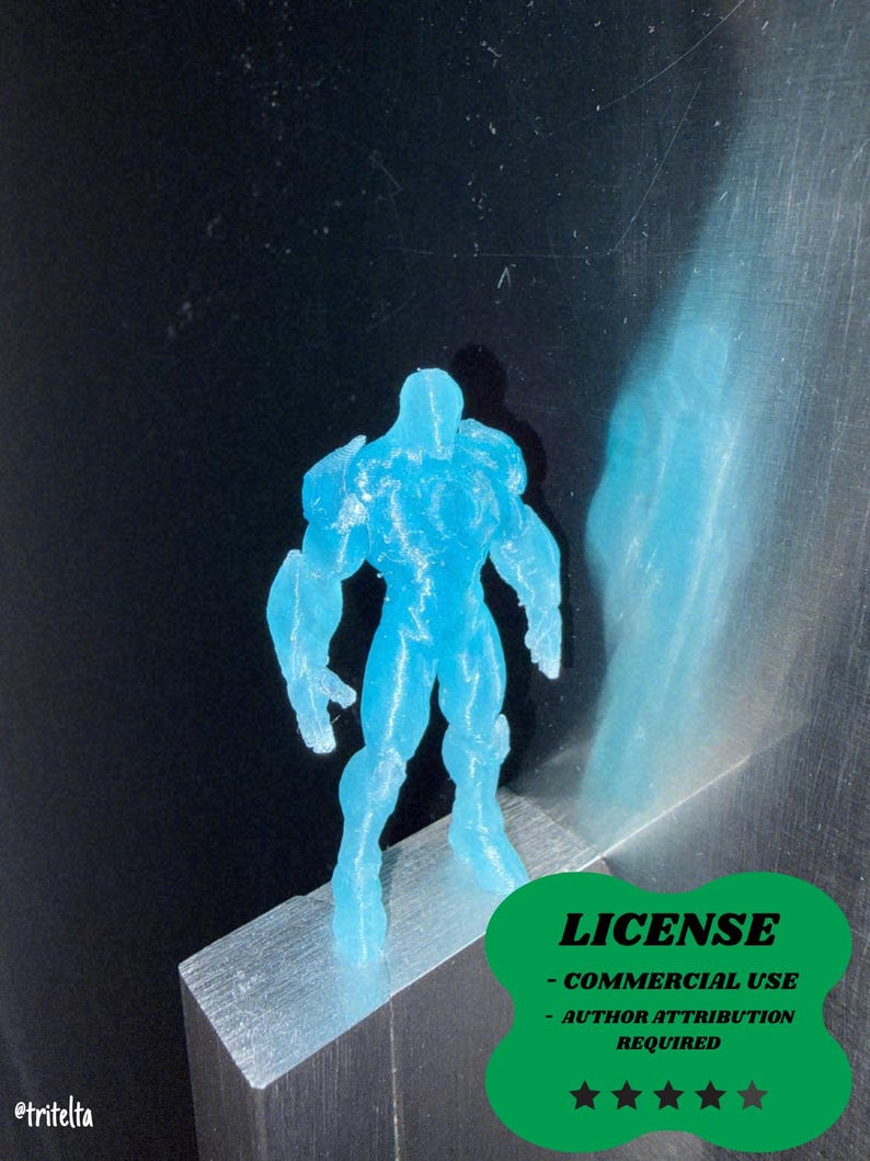 May include: A translucent blue figurine of a muscular humanoid figure. The figure is standing on a small, silver block. The image includes a green badge with the word "LICENSE" and text below it. The figure is approximately 3 inches tall.