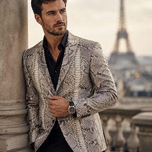 May include: A snakeskin-patterned blazer with a black shirt and black pants. The jacket has a neutral color palette of beige, brown, and gray. A gold watch with a black band is visible on the wrist. The Eiffel Tower is in the background.