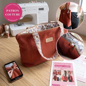 May include: A rust-colored corduroy tote bag with floral lining, featuring a rectangular leather patch labeled SLOW living. The bag has two handles and a zippered top closure. Included are sewing pattern instructions and a smartphone display.