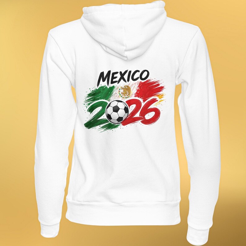 May include: White hooded sweatshirt featuring the word "MEXICO" in black, with a soccer ball and the number "2026" in red. The design incorporates the colors of the Mexican flag: green, white, and red, creating a patriotic theme.