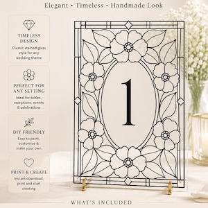 May include: A rectangular clear acrylic table number sign featuring a black printed floral stained glass pattern with the number 1 in the centre. The sign is supported by a gold metal stand and includes text detailing features and download instructions.