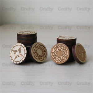 May include: Wooden game pieces with engraved designs. The pieces are round with dark brown edges and light brown centers. Some feature geometric starburst patterns, while others display Celtic knot designs. The word "Crafty" is repeated in the background.
