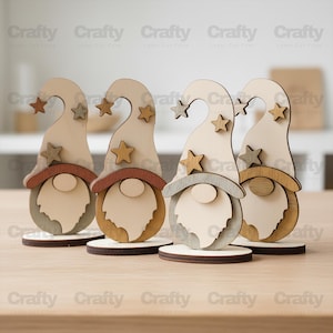 May include: Four wooden gnome figurines with star accents. Each gnome has a light-colored hat with a curved top and a star, a beard, and a circular base. The text "Crafty" is repeated across the top and bottom of the image.