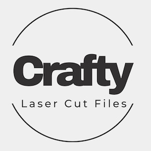 May include: A black and white logo with the word "Crafty" in bold letters, encircled by a partial black circle. Below the word "Crafty" is the text "Laser Cut Files". The background is a light gray.