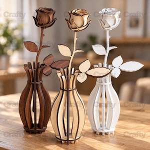May include: Three laser-cut wooden rose sculptures in dark brown, light tan, and white, each standing in a matching slotted wooden vase. The flowers feature layered petals, a single stem, and two leaves, all constructed from flat, interlocking wood pieces.