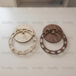 May include: Two wooden wall clocks with a gear-like design. One clock is light-colored, the other is dark brown. Both have a circular frame with numbers and a central gear with gold-colored hands. The clocks are laser cut.
