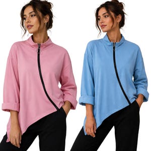 May include: Two long-sleeve pullover tops, one in light pink and one in light blue, featuring a mock neck, a black diagonal zip closure with a circular pull, and an asymmetrical hemline. Both tops are paired with solid black trousers.
