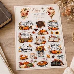 May include: A sticker sheet featuring various autumn-themed illustrations and religious text, including pumpkins, sunflowers, coffee mugs, and open books. The header reads Effy's Creations Studio, with phrases like In every thing give thanks and Grateful.