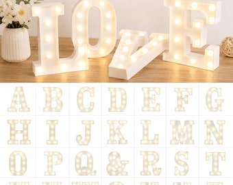 May include: White marquee letters spelling LOVE, each featuring integrated warm LED bulbs. The set includes individual light-up letters from A to Z, an ampersand, and an at symbol, all designed with a clean, block-style font and a smooth finish.