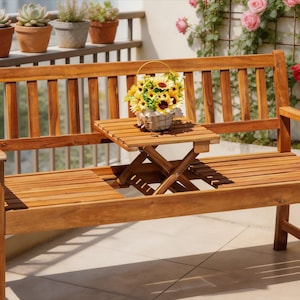 May include: A wooden bench with a built-in side table. The bench is made of light brown wood and has a slatted seat and back. A small table is attached to the bench, and a basket of sunflowers sits on top. Potted plants are visible in the background.
