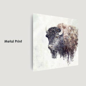 May include: A watercolor painting of a bison with a white background. The bison is facing left and has a dark brown body with a white face. The painting has a soft, dreamy feel.