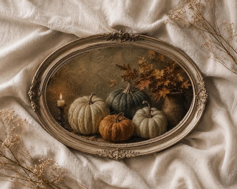 May include: An oval-shaped framed wall art piece featuring a still life painting of four pumpkins in shades of white, green, and orange, a lit candle in a dark holder, and a vase filled with autumn foliage against a textured, dark background.