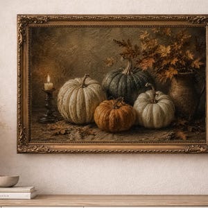 May include: A framed oil painting depicting a still life scene with four pumpkins of varying sizes and colors, including white, green, and orange, arranged next to a lit candle in a dark holder and a ceramic pitcher filled with autumn leaves.