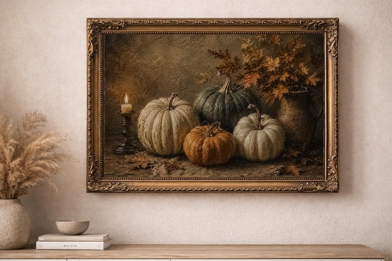 May include: A framed oil painting depicting a still life scene with four pumpkins of varying sizes and colors, including white, green, and orange, arranged next to a lit candle in a dark holder and a ceramic pitcher filled with autumn leaves.