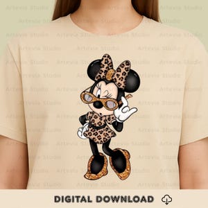May include: A beige t-shirt with a cartoon Minnie Mouse design. Minnie is wearing a leopard print outfit and sunglasses, making a rock-and-roll hand gesture. The words "DIGITAL DOWNLOAD" are at the bottom of the image.