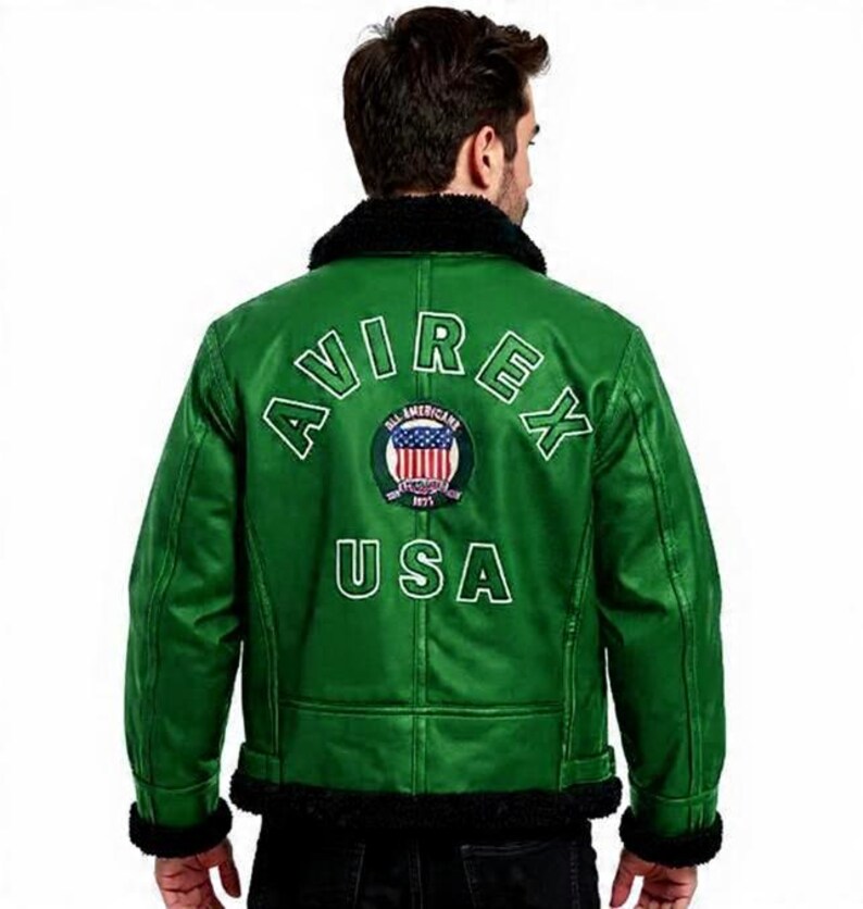May include: Green leather jacket with black faux fur collar and trim. The back displays the white text "AVIREX USA" and a circular emblem. A classic bomber jacket style.
