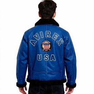 May include: A blue leather jacket with a black faux fur collar and cuffs. The back of the jacket features the text "AVIREX" and "USA" in white, along with a circular patch with the American flag.