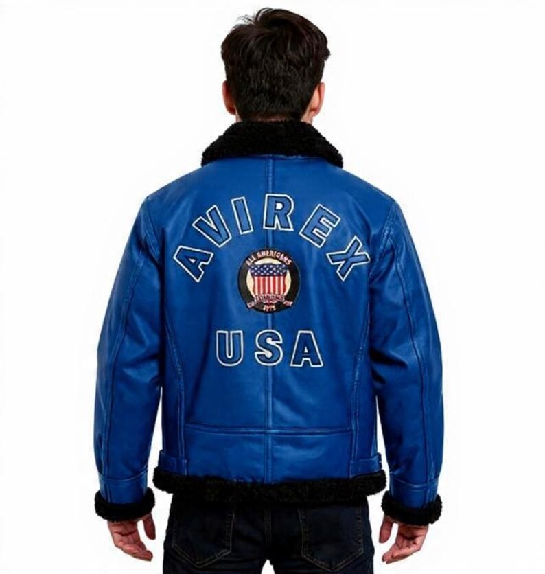 May include: A blue leather jacket with a black faux fur collar and cuffs. The back of the jacket features the text "AVIREX" and "USA" in white, along with a circular patch with the American flag.