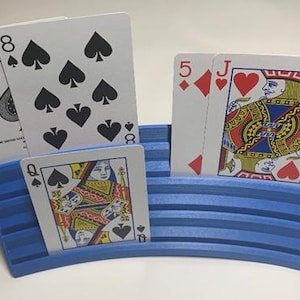 May include: A rustic wooden sign with the text "Welcome" in a handwritten style. The sign is painted white with a distressed finish, and features a decorative floral element in the corner. The background is a blurred image of a wooden surface.