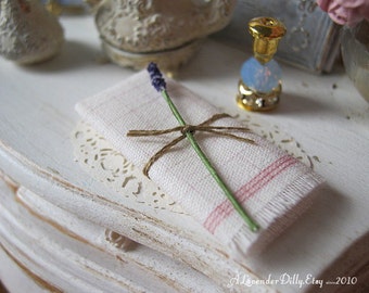 Lavender Sprig with Folded Red Kitchen Towel for Dollhouse Miniatures.