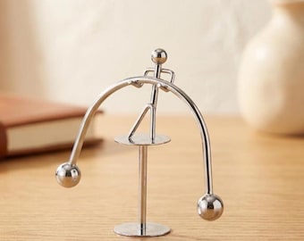 The Iron Balance: Chrome Kinetic Weightlifter Sculpture