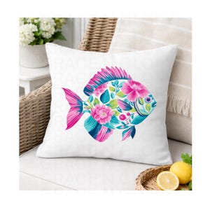 May include: White square throw pillow featuring a colorful fish design. The fish is decorated with pink flowers, teal and blue accents, and green leaves. The pillow is on a wicker chair.
