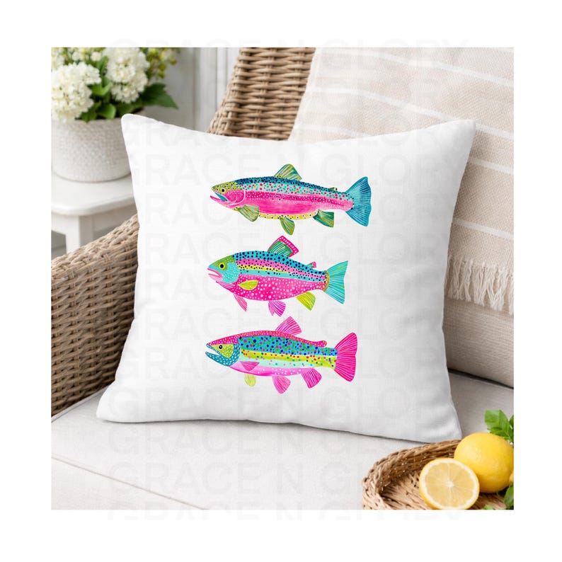 May include: White throw pillow featuring a watercolor design of three colorful rainbow trout. The fish have pink, blue, green, and yellow details. The pillow is on a wicker chair with a white background.