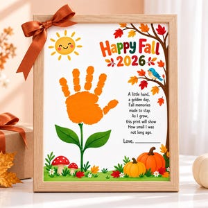 May include: A framed print featuring an orange handprint shaped like a flower, a smiling sun, pumpkins, mushrooms, and a blue bird. The text reads Happy Fall 2026 and includes a poem about growing up. A brown ribbon is tied to the top corner of the frame.