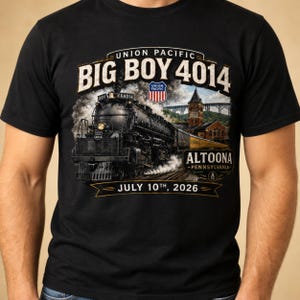 May include: A black t-shirt featuring a graphic of the Union Pacific Big Boy 4014 steam locomotive. The design includes the text "UNION PACIFIC BIG BOY 4014", "ALTOONA PENNSYLVANIA", and "JULY 10TH, 2026" with a detailed illustration of the train.