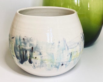 Organic curvy wheel thrown planter with a hand painted design in greens and blues. Made in Norfolk