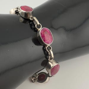 May include: A set of three ceramic mugs with a speckled, matte finish. The mugs are in cream, light grey, and dark grey. Each mug has a simple, minimalist design, ideal for coffee or tea.