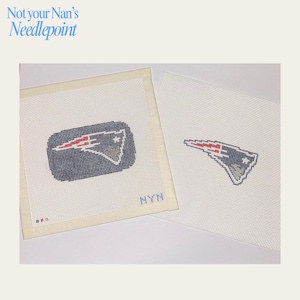 May include: Two square pieces of white needlepoint canvas featuring the New England Patriots logo stitched in navy blue, red, and silver. The left canvas includes a navy blue background behind the logo and the letters NYN in the bottom right corner.