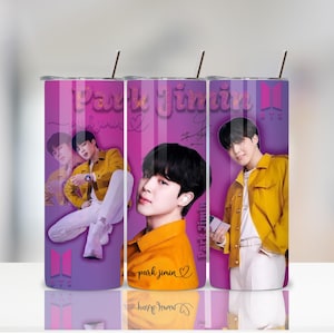 May include: Three stainless steel tumblers with images of Park Jimin from BTS. Each tumbler features a different photo of Jimin in a yellow jacket, with the words "Park Jimin" and BTS logos. The background is purple.