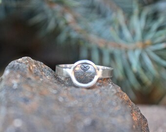 Sterling Silver Circle Ring with a heart stamped on the inside, seen  directly through the circle