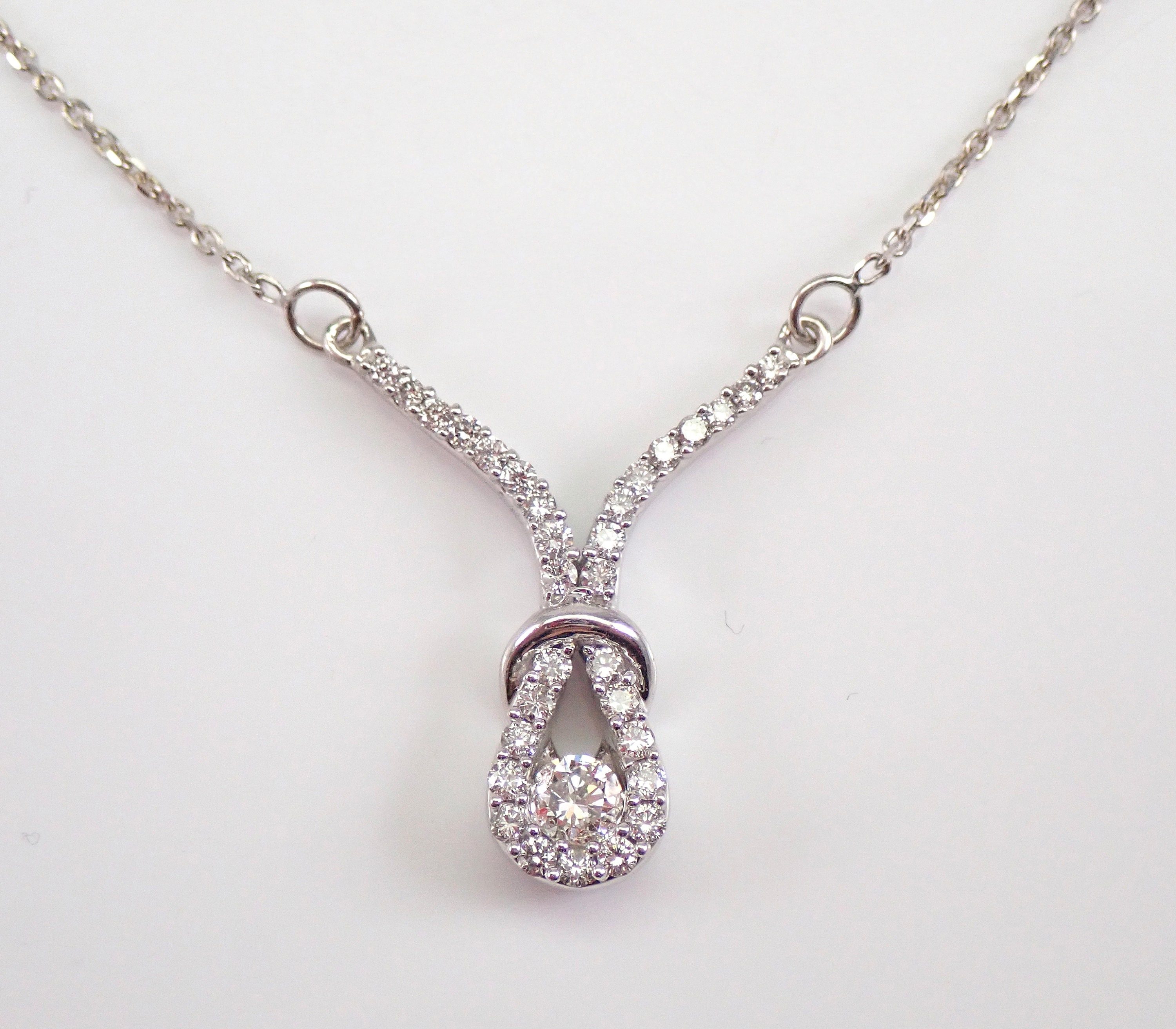 14k White Gold Diamond Love Knot Necklace 1/6 Ctw | Sarraf.com
