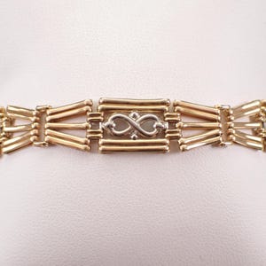 Pulsera vintage de infinito en oro amarillo de 14 quilates: eslabón con dije de estación bicolor de Unique Estate
