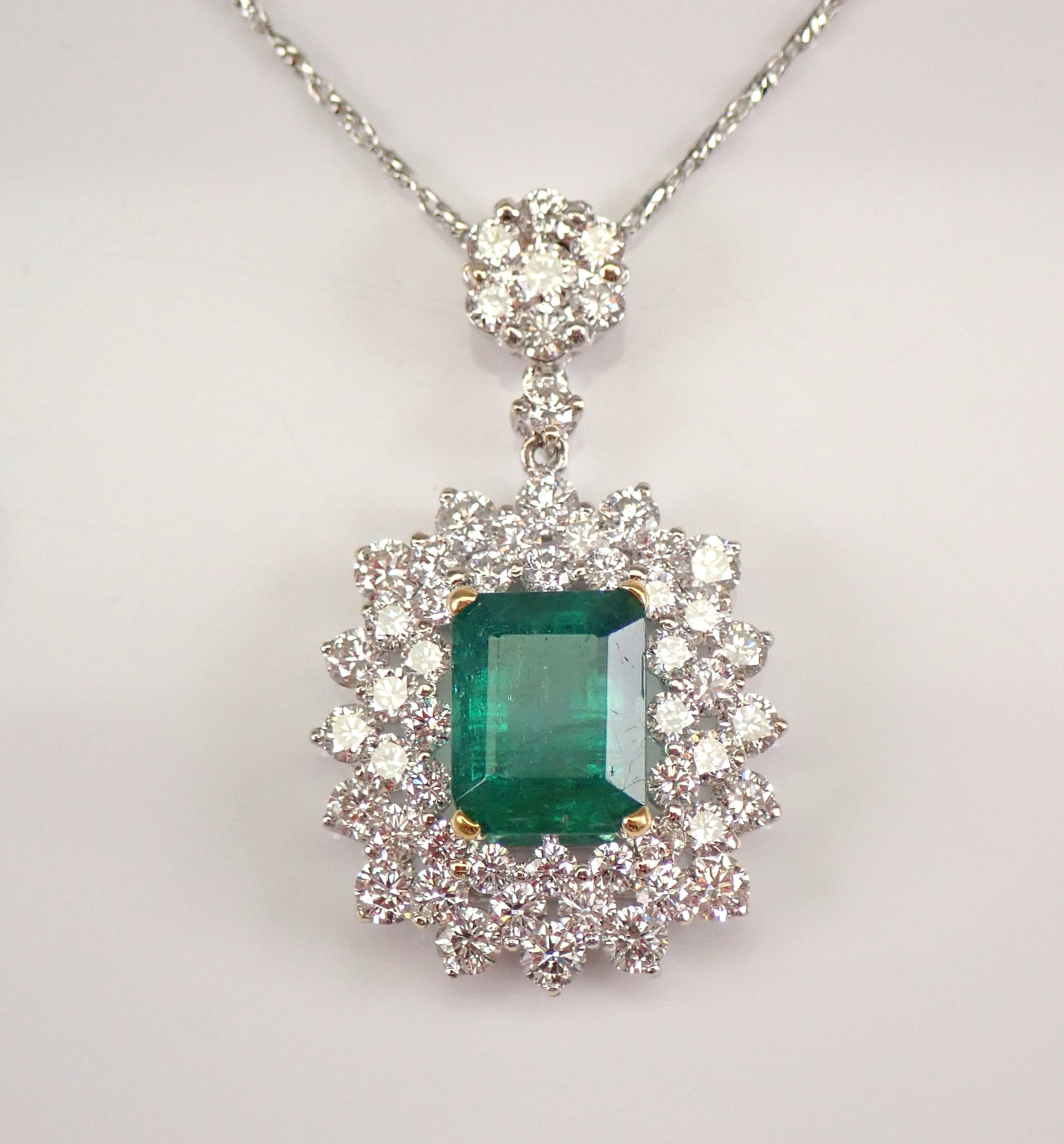 9ct White Gold Emerald And Diamond 0.12ct Halo Pendant