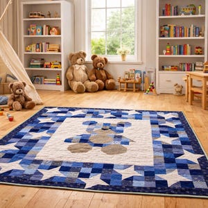May include: A blue and white quilt with a teddy bear design in the center. The quilt features a border of white stars and blue squares. The quilt is on a hardwood floor in a child's playroom, surrounded by teddy bears and toys.