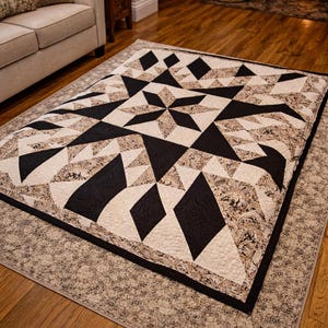 May include: A geometric quilt featuring a starburst design in black, cream, and patterned tan fabrics. The quilt is placed on a patterned rug, creating a cozy atmosphere. The quilt's dimensions are not visible.