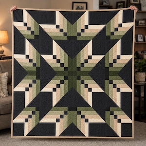 May include: A square quilt featuring a large central star pattern composed of geometric shapes in shades of olive green, cream, and beige. The design is set against a solid black background with a thin tan border framing the entire piece.