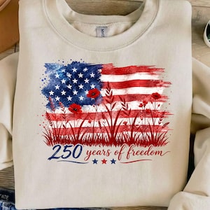 Patriotic floral USA flag PNG graphic displayed on a colorful pastel sweatshirt mockup.