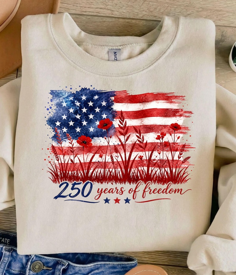 Patriotic floral USA flag PNG graphic displayed on a colorful pastel sweatshirt mockup.