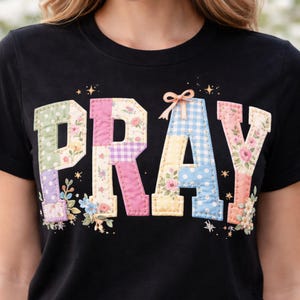 May include: Black t-shirt with the word "PRAY" in a patchwork design. The letters feature floral, polka dot, and gingham patterns in pastel colors. The shirt also has the text "PNG+PDF" at the bottom.