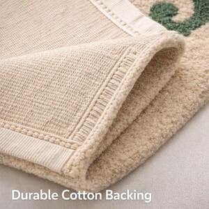 Backside of wool rug with folded corner showing durable cotton backing and stitching detail, high quality construction and finishing
