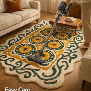 Person vacuum cleaning hand tufted wool rug in modern home, easy care maintenance demonstration in natural light living room