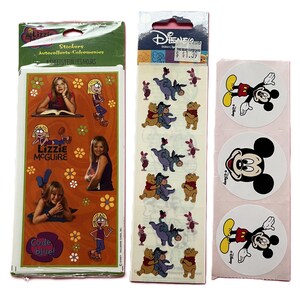 May include: Three sets of character stickers including a Lizzie McGuire sheet with orange background and floral accents, a Disney Winnie the Pooh sheet featuring Eeyore and Piglet, and a strip of three circular stickers showing Mickey Mouse.